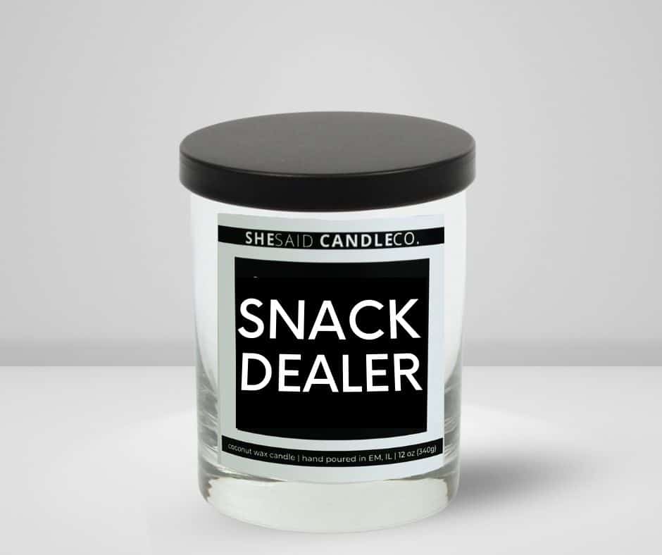 10oz clear jar candle made by She Said Candle Co labeled Snack Dealer